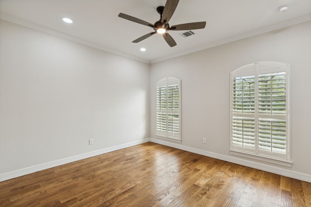 spare room featuring hardwood / wood-style floors, ceiling fan, and crown molding