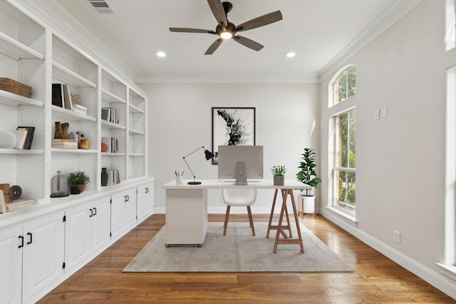 home office featuring plenty of natural light, light hardwood / wood-style floors, ornamental molding, and ceiling fan