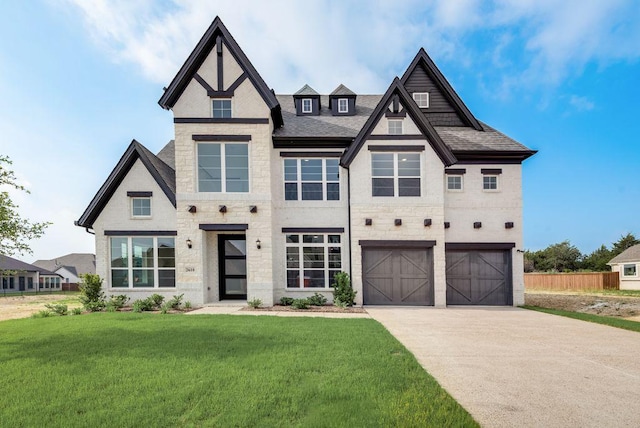 view of front of property featuring a front yard and a garage