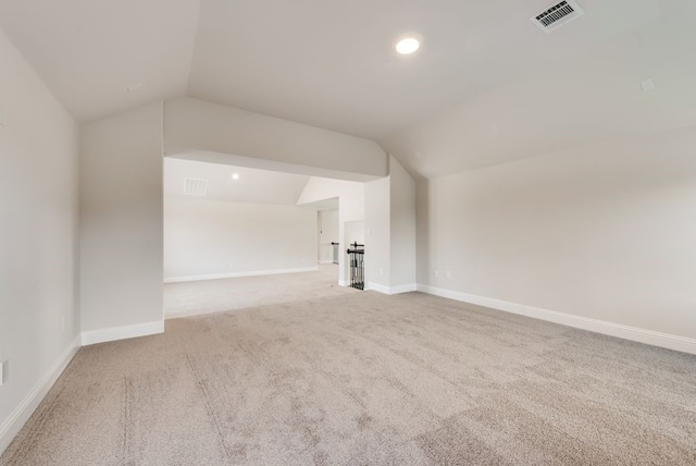 unfurnished living room featuring vaulted ceiling and carpet flooring