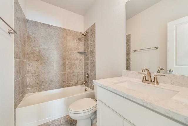 full bathroom with toilet, vanity, and tiled shower / bath