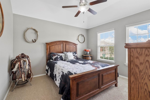 bedroom featuring light carpet and ceiling fan