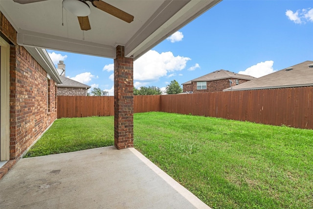 view of yard with a patio and ceiling fan