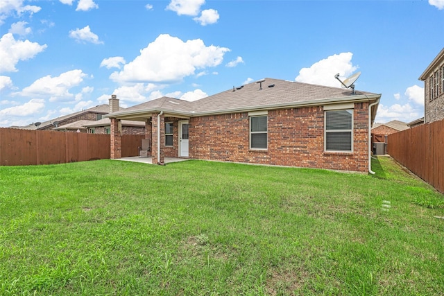 back of property featuring central AC, a patio area, and a lawn