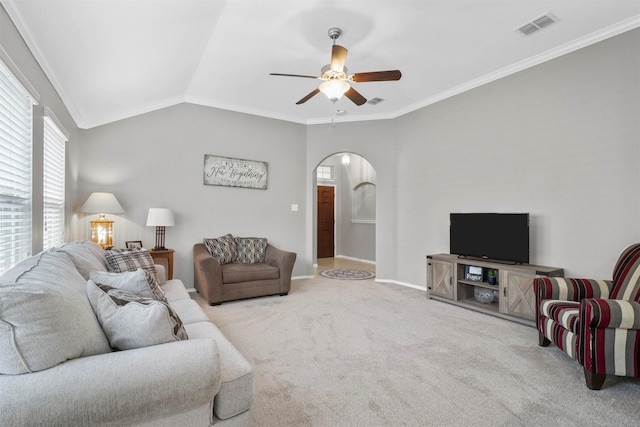 carpeted living room featuring crown molding, lofted ceiling, and ceiling fan