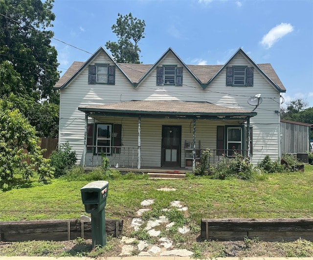 view of front facade with a front yard and a porch