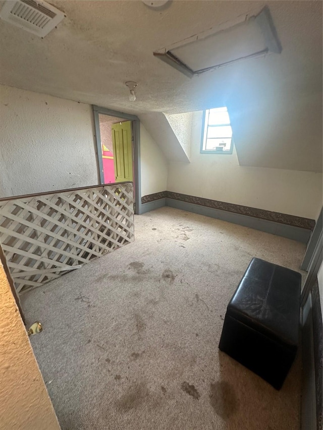 bonus room featuring carpet floors, a textured ceiling, and vaulted ceiling