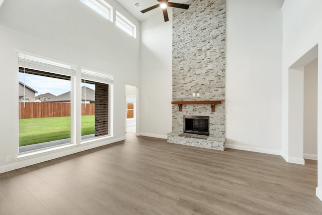 unfurnished living room featuring a fireplace, hardwood / wood-style floors, and a healthy amount of sunlight