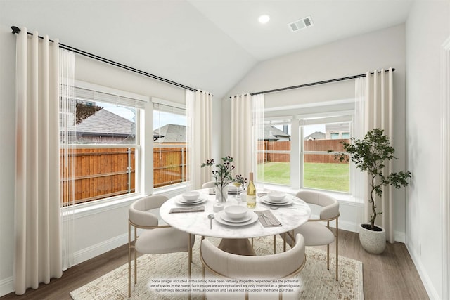 dining area featuring hardwood / wood-style floors and lofted ceiling