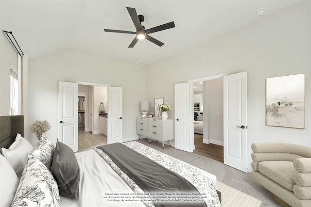 bedroom with ceiling fan, light hardwood / wood-style flooring, and lofted ceiling