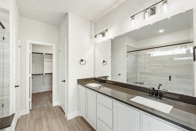 bathroom with tile patterned floors, double vanity, and a shower with door