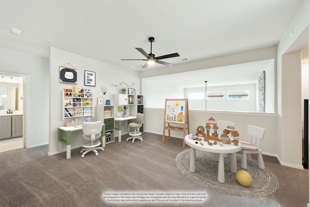 interior space with sink, carpet flooring, ceiling fan, and plenty of natural light