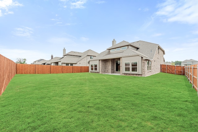 back of property featuring a lawn