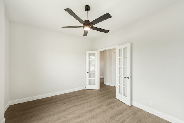 unfurnished room with ceiling fan, french doors, and light hardwood / wood-style floors