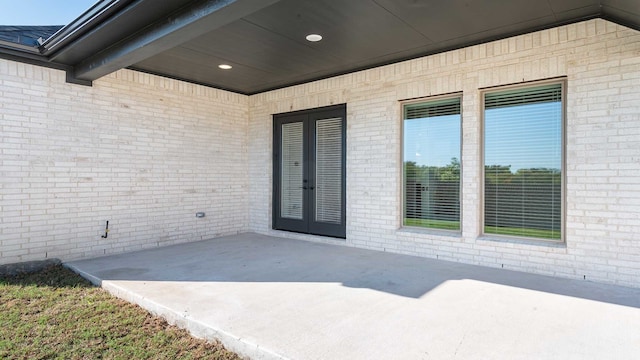 view of exterior entry featuring a patio and french doors