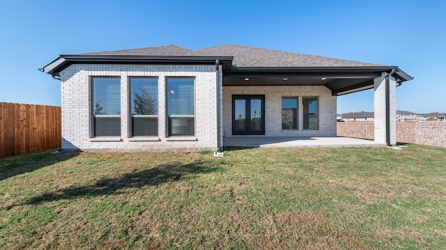 rear view of house featuring a yard and a patio