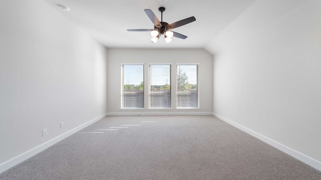 unfurnished room featuring lofted ceiling, light colored carpet, and ceiling fan