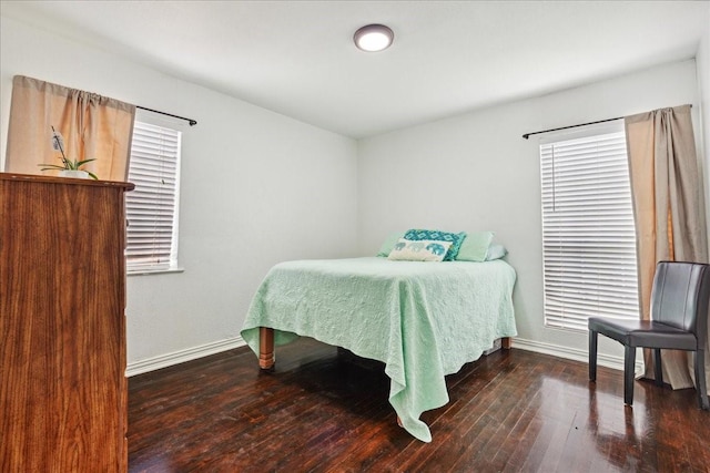 bedroom with dark hardwood / wood-style floors