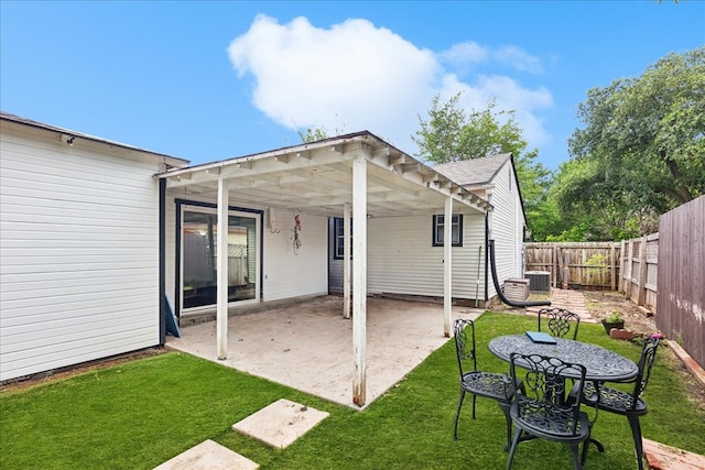 rear view of house featuring a yard and a patio area