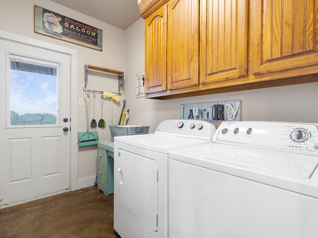 laundry room with washing machine and dryer and cabinets