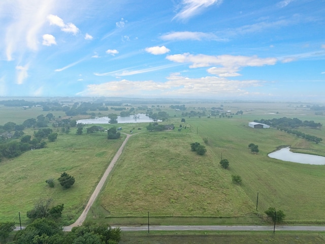 drone / aerial view with a rural view and a water view