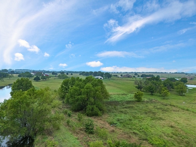 bird's eye view with a water view and a rural view