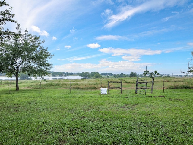 view of yard with a water view and a rural view