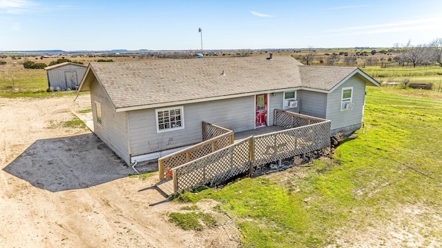 view of front of home featuring a storage shed