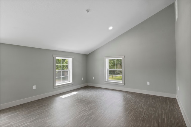 spare room featuring vaulted ceiling and hardwood / wood-style floors