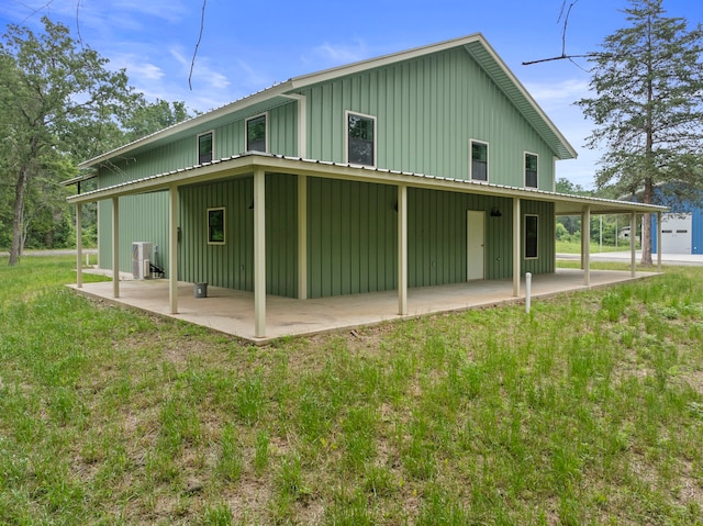 rear view of house with a patio area and a yard