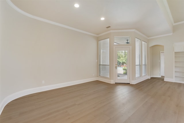 entryway featuring ornamental molding, french doors, hardwood / wood-style floors, and a towering ceiling