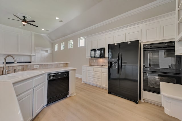 unfurnished living room with ornamental molding, a tiled fireplace, ceiling fan, and light wood-type flooring