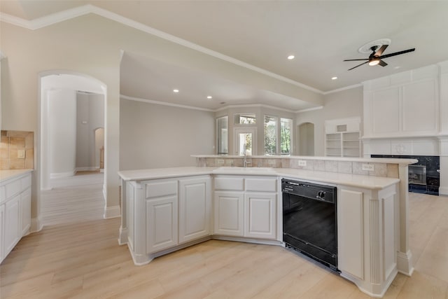 unfurnished living room with lofted ceiling, crown molding, light wood-type flooring, ceiling fan, and a fireplace