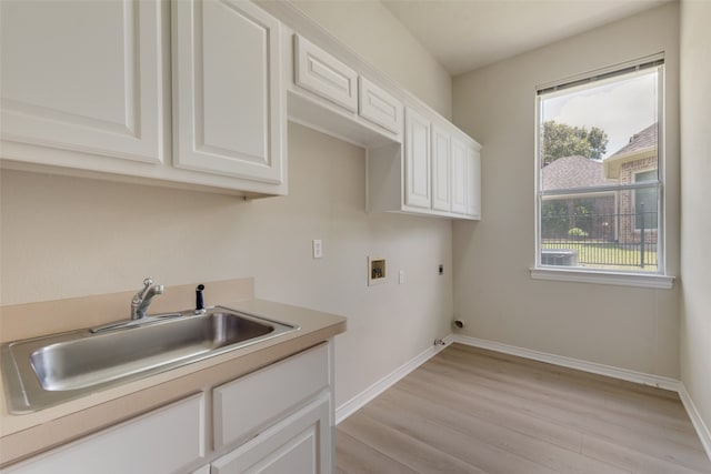 kitchen featuring light wood-type flooring, ornamental molding, sink, black dishwasher, and backsplash