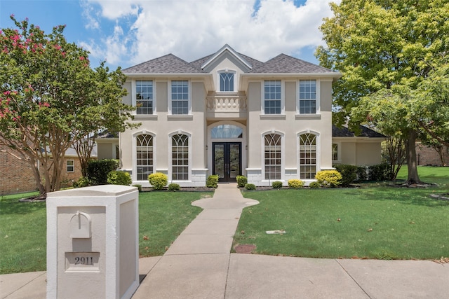 view of front facade with french doors and a front lawn