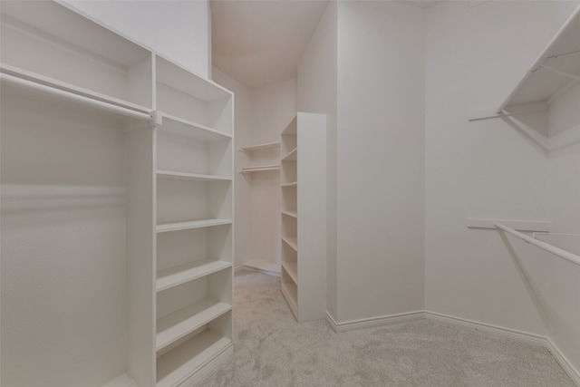 unfurnished bedroom with light colored carpet, ceiling fan, and crown molding