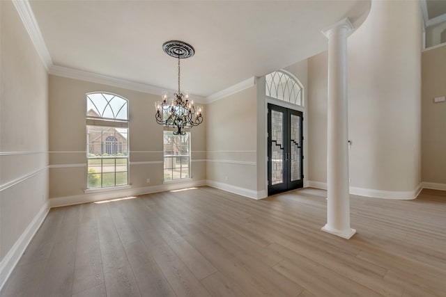 foyer entrance featuring hardwood / wood-style flooring, crown molding, and a high ceiling