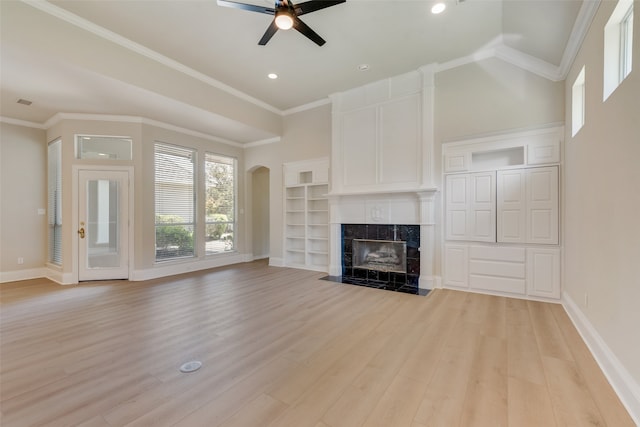 unfurnished dining area featuring wood-type flooring, a notable chandelier, crown molding, and ornate columns