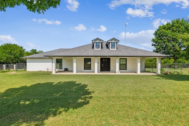 view of front of house featuring a front lawn and a patio