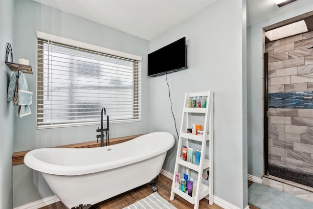 bathroom featuring hardwood / wood-style flooring and independent shower and bath