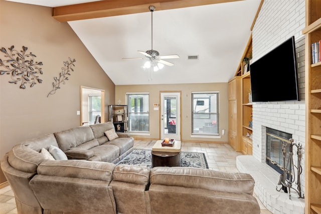 living room with ceiling fan, built in features, lofted ceiling, and a fireplace