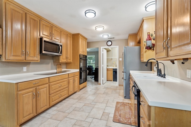 kitchen with sink and black appliances