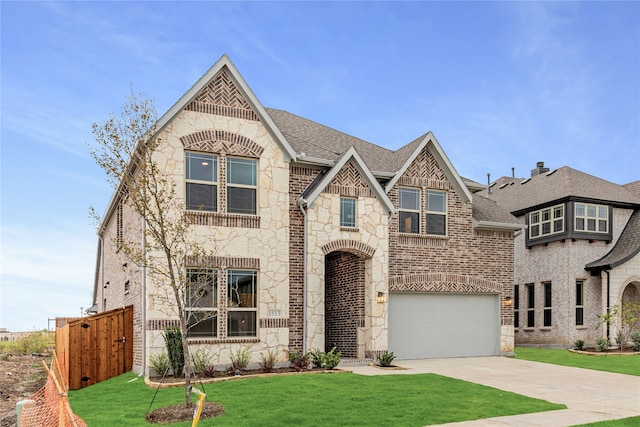 view of front of property featuring a front yard and a garage