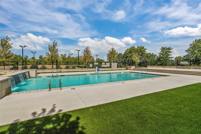 pool with a yard, fence, and a patio