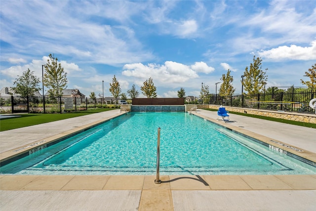 pool with fence and a patio