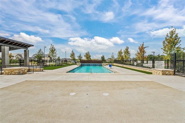 pool featuring a patio area and fence