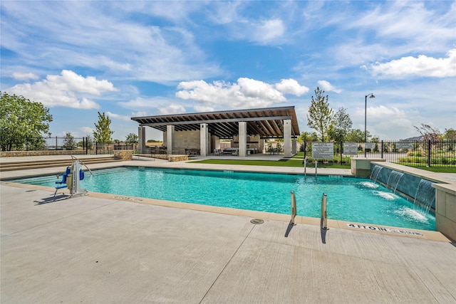 community pool with a patio and fence