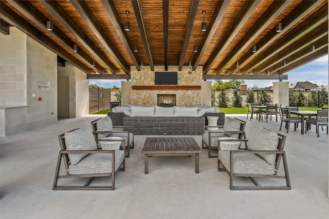 view of patio featuring an outdoor living space with a fireplace, fence, and outdoor dining area