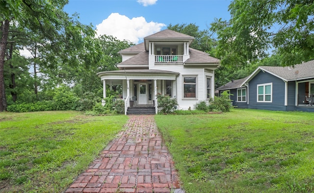 view of front of house featuring a front yard and covered porch