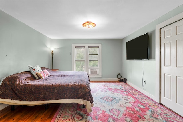 bedroom with hardwood / wood-style flooring